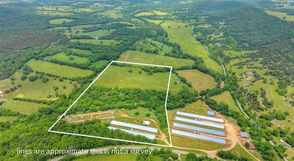 6112 Highway 21 in Berryville, AR. 30.35 acre farm with two former poultry houses.